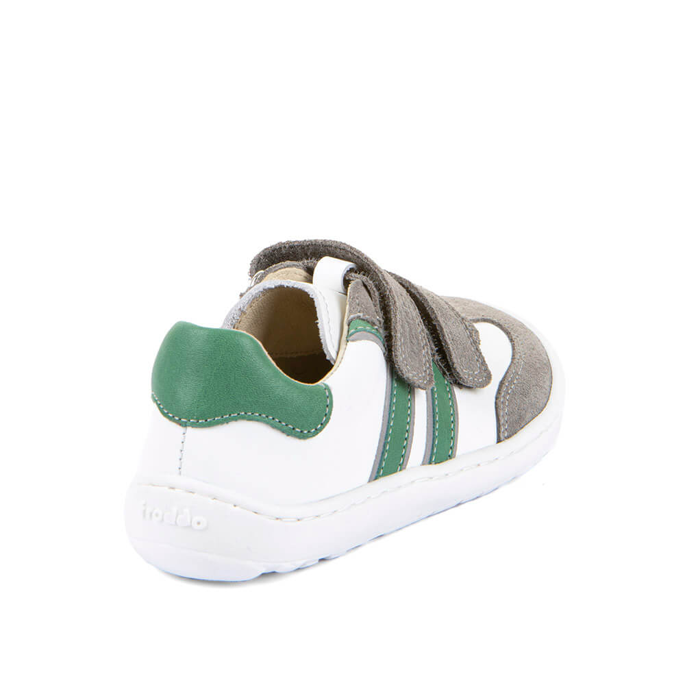 White children's barefoot shoe with green accents 
