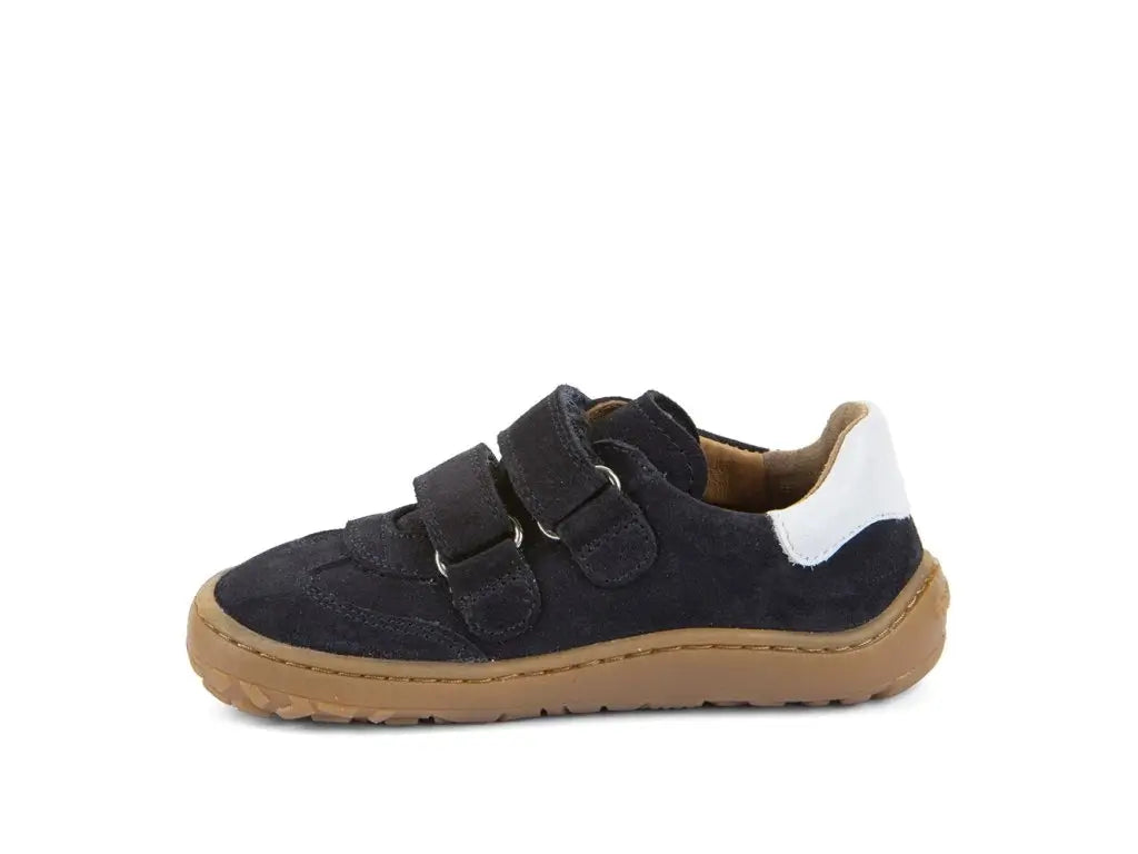 Children's barefoot shoe with black suede upper, brown sole, and white patch